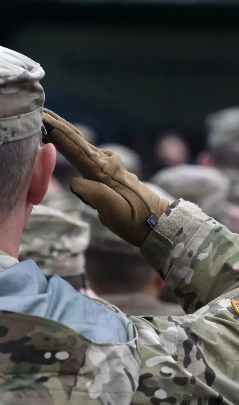 A service member salutes during a ceremony